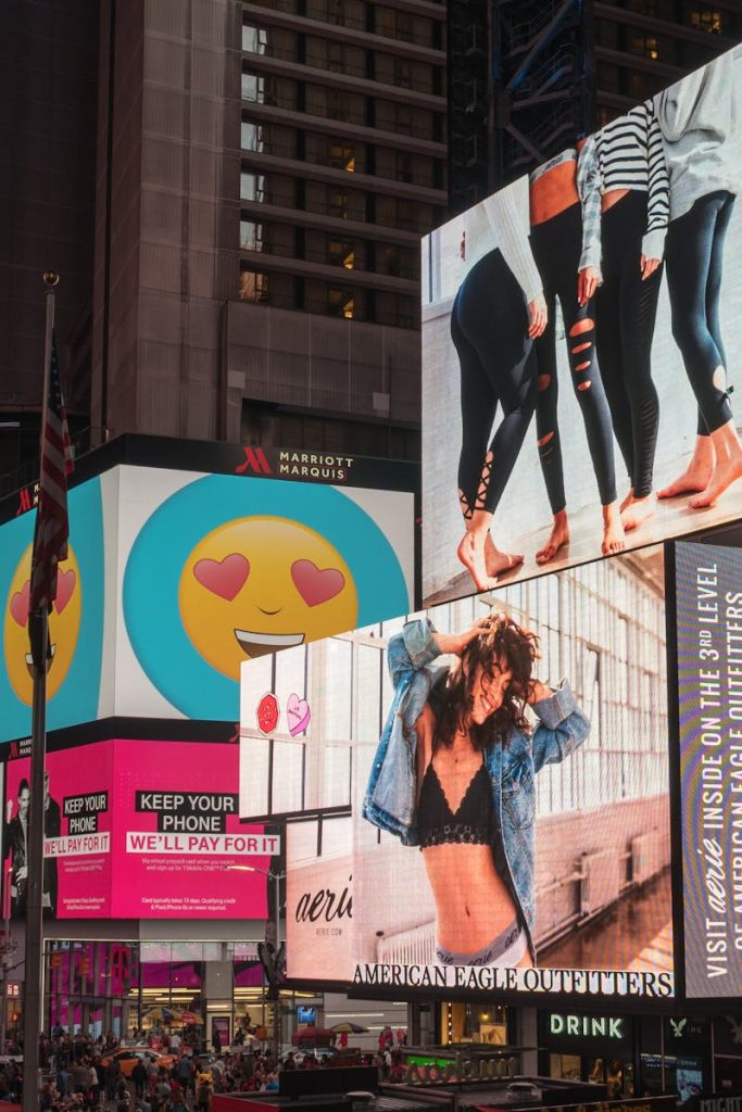 Colorful billboards light up New York City's iconic Times Square at night, with vibrant ads and bustling crowds.